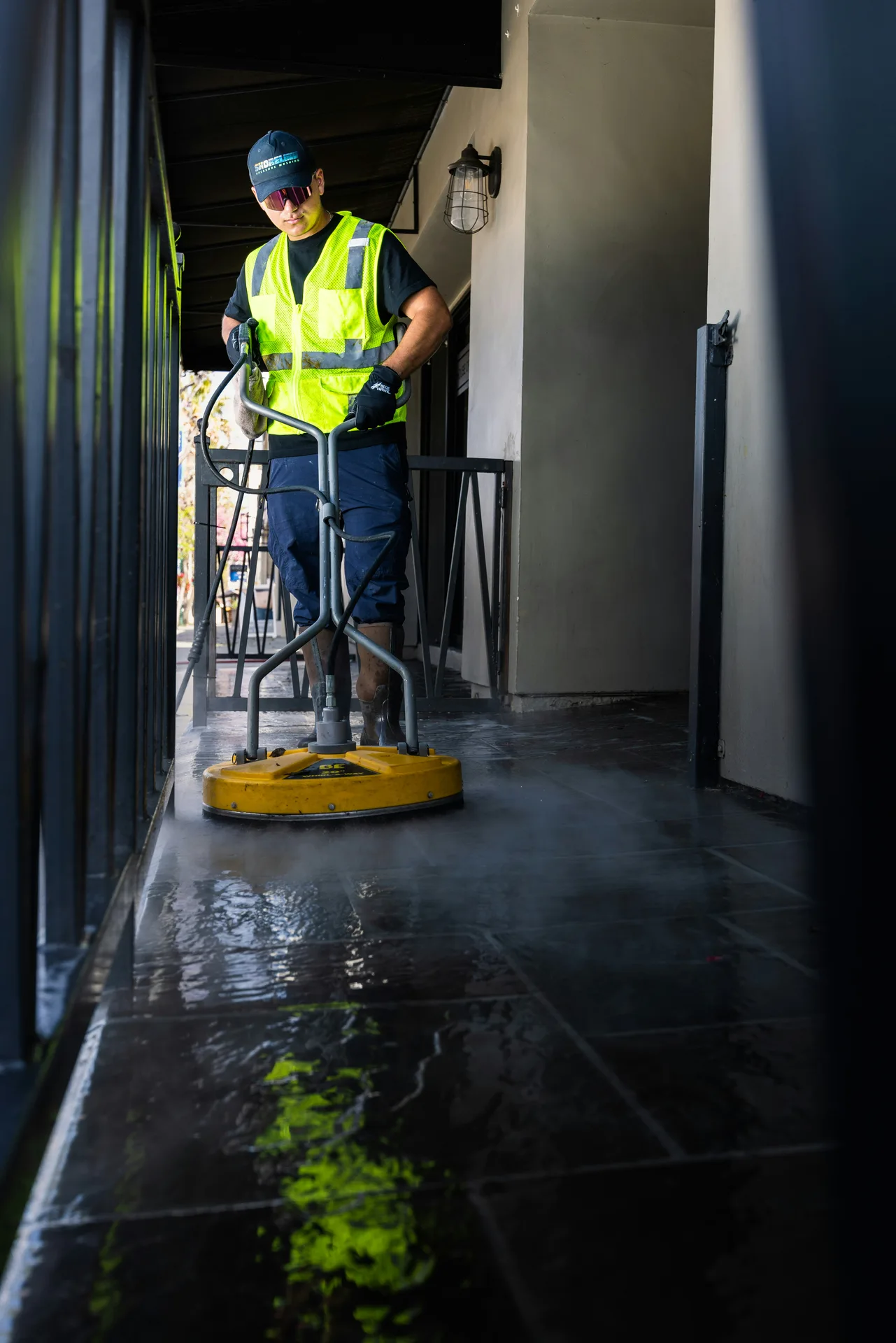 Technician Using Surface Cleaner on /oil-stain-removal/ — Montreal Pressure Washing Montreal